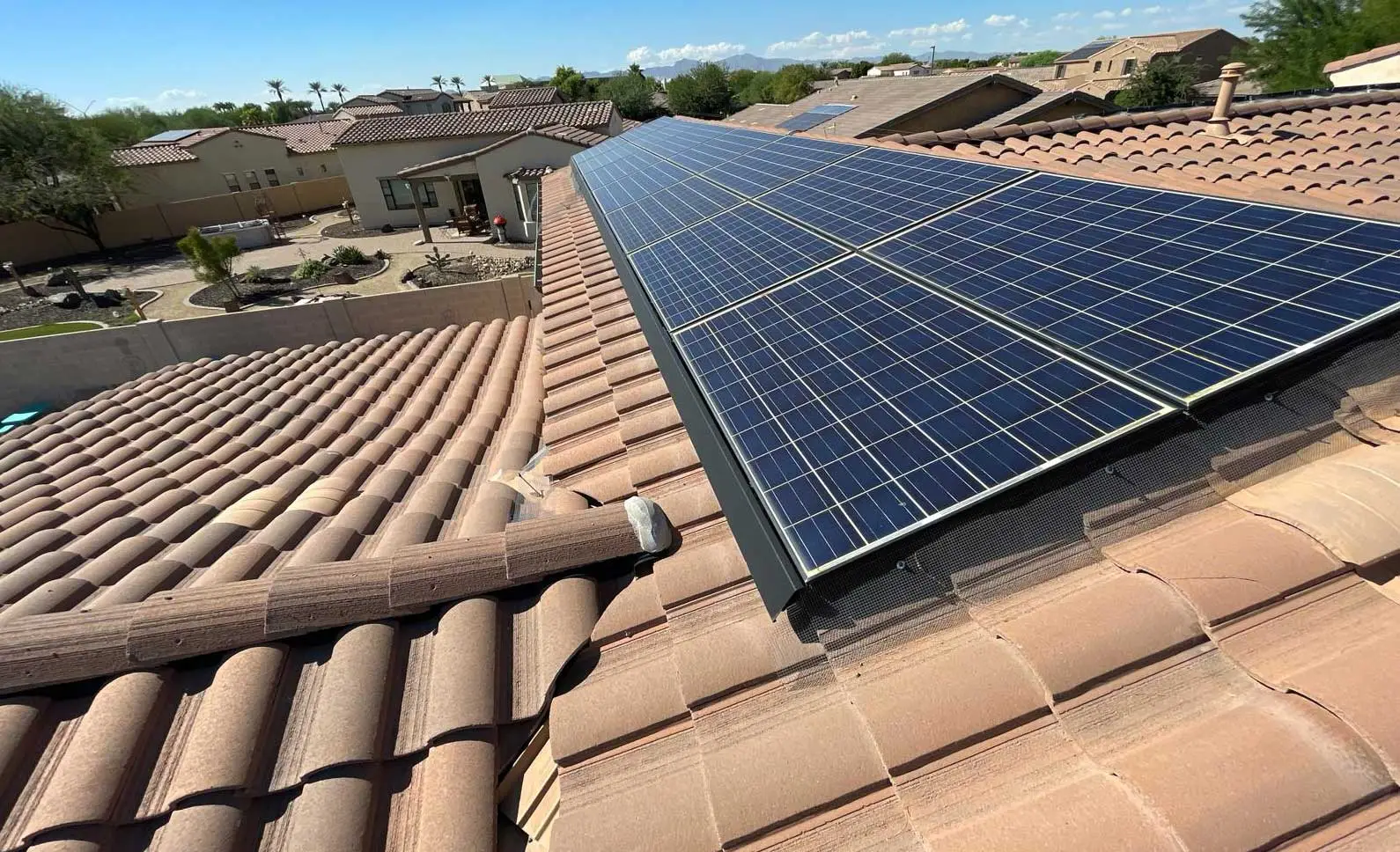 Rooftop solar array on a tile roof in an Arizona neighborhood